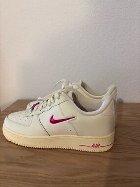 Nike Cream Leather Low-Top Sneakers with Pink Metallic Swoosh and Pink Accents